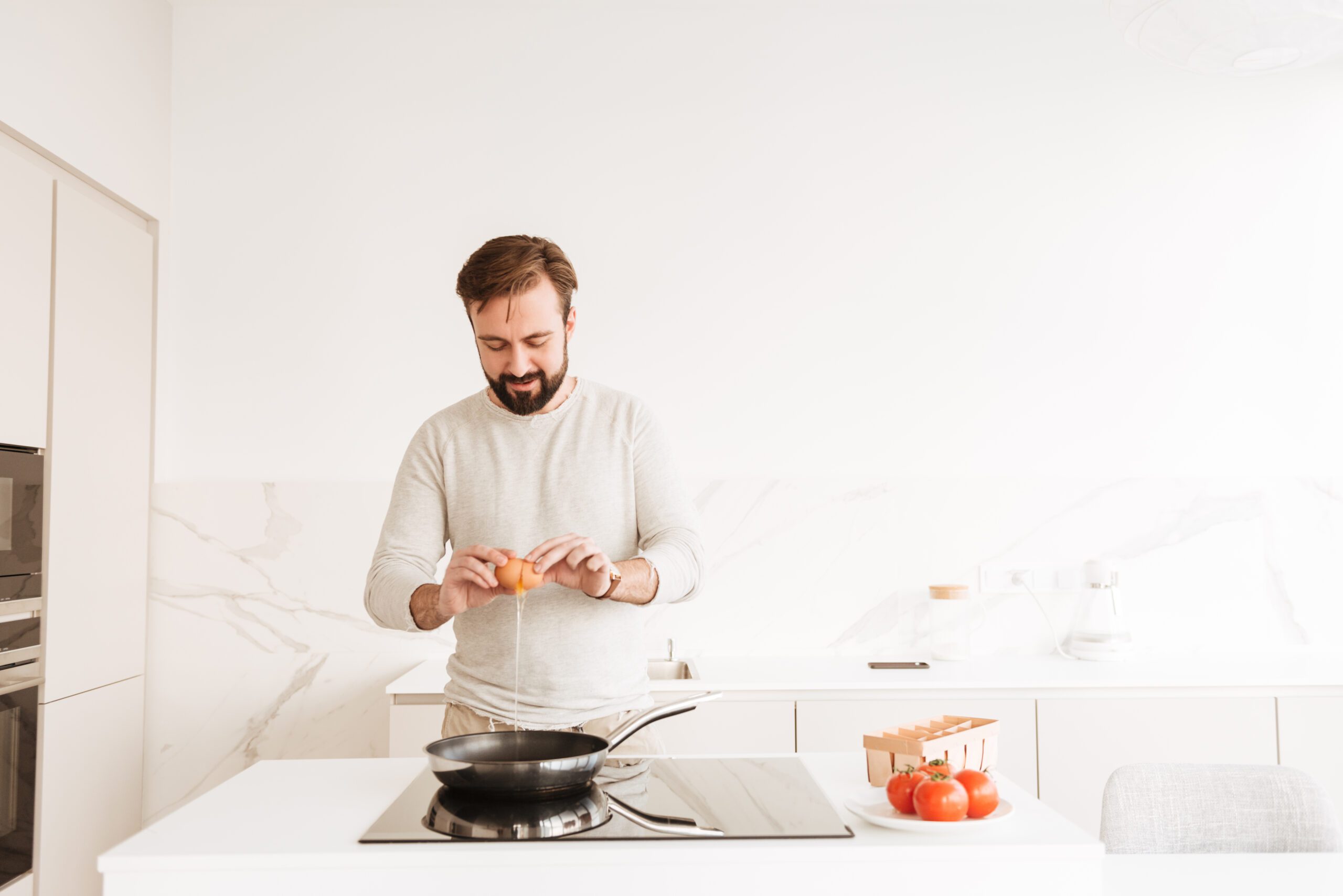 Photo of european man with short brown hair and beard cooking